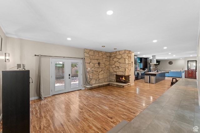 4281 S Nielsen Way, West Valley City, UT 84119 - living area featuring french doors, recessed lighting, light wood-style flooring, and a stone fireplace