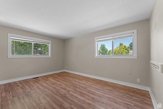 4281 S Nielsen Way, West Valley City, UT 84119 - spare room featuring healthy amount of natural light and wood finished floors
