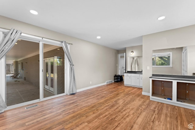 4281 S Nielsen Way, West Valley City, UT 84119 - unfurnished living room featuring light wood-style floors and recessed lighting