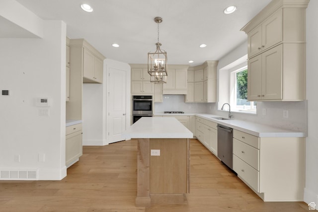 1378 E Orchard Ridge Ln, Kaysville, UT 84037 - kitchen with stainless steel appliances, a center island, light wood finished floors, recessed lighting, and light countertops