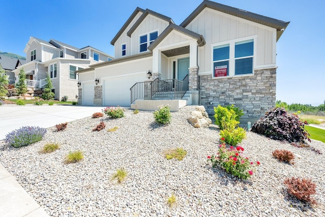 1378 E Orchard Ridge Ln, Kaysville, UT 84037 - craftsman house featuring board and batten siding, stone siding, an attached garage, and driveway