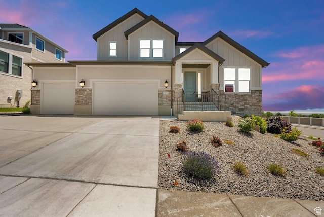 1378 E Orchard Ridge Ln, Kaysville, UT 84037 - view of front facade featuring board and batten siding, stone siding, driveway, and an attached garage