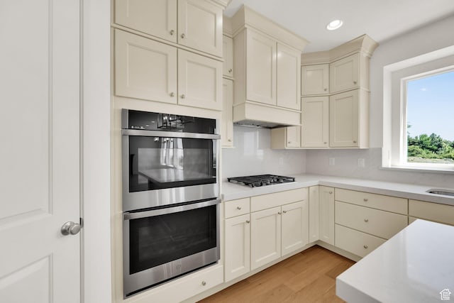 1378 E Orchard Ridge Ln, Kaysville, UT 84037 - kitchen featuring stainless steel appliances, light countertops, light wood-style floors, custom exhaust hood, and recessed lighting