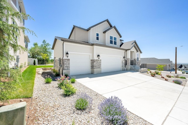 1378 E Orchard Ridge Ln, Kaysville, UT 84037 - view of front facade featuring stone siding, board and batten siding, driveway, and an attached garage