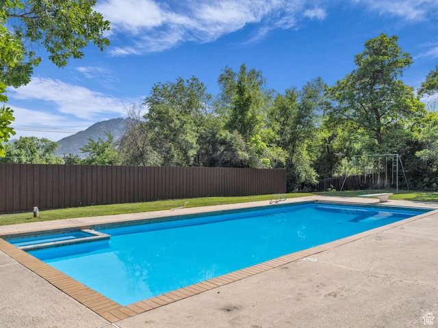 1499 E River Oaks Dr, Sandy, UT 84093 - view of pool featuring a mountain view, a fenced backyard, a patio area, a pool with connected hot tub, and a diving board