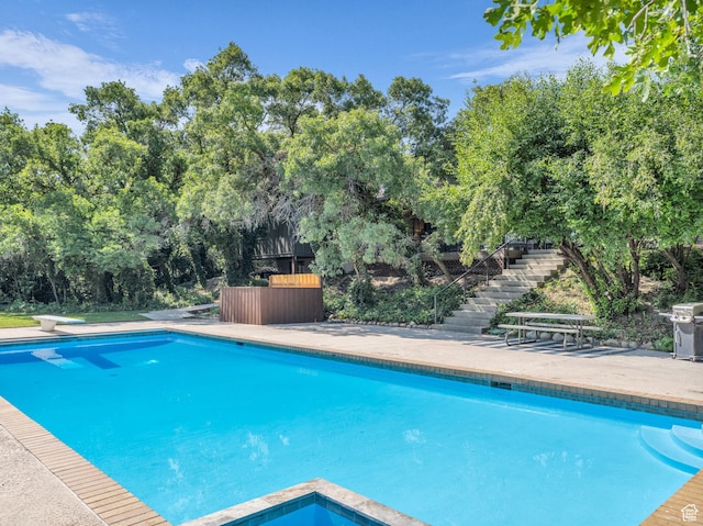 1499 E River Oaks Dr, Sandy, UT 84093 - outdoor pool featuring stairway, grilling area, view of scattered trees, and a diving board