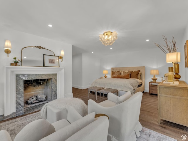 1499 E River Oaks Dr, Sandy, UT 84093 - bedroom featuring wood finished floors, recessed lighting, a chandelier, and a premium fireplace