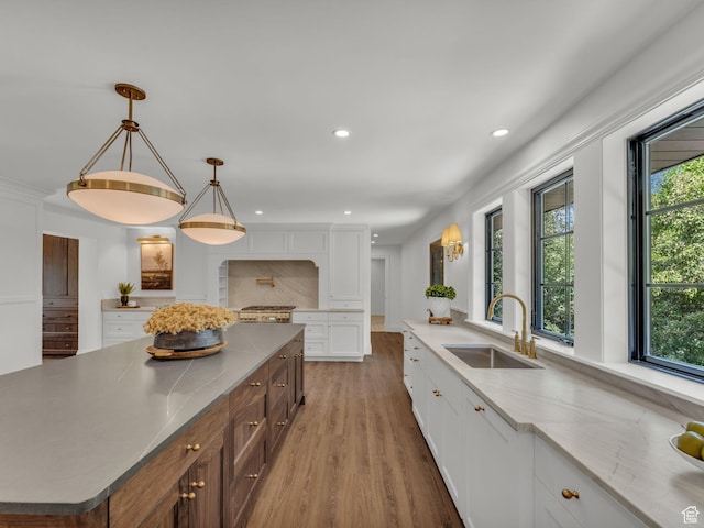 1499 E River Oaks Dr, Sandy, UT 84093 - kitchen featuring white cabinetry, light wood finished floors, recessed lighting, pendant lighting, and range
