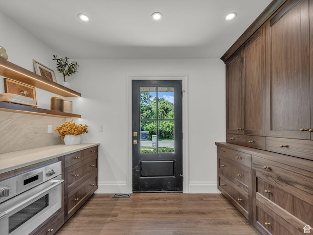 1499 E River Oaks Dr, Sandy, UT 84093 - kitchen featuring oven, open shelves, light wood-style floors, recessed lighting, and dark brown cabinets
