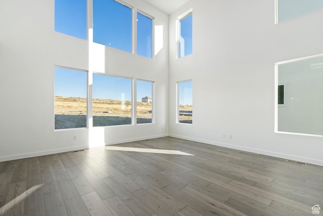 6941 W Farnsworth Peak Dr S Unit 316, West Jordan, UT 84081 - unfurnished room with wood finished floors and a towering ceiling