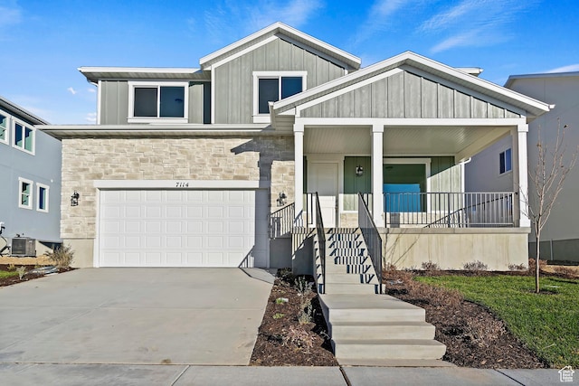 6941 W Farnsworth Peak Dr S Unit 316, West Jordan, UT 84081 - view of front of home featuring stone siding, covered porch, board and batten siding, and driveway