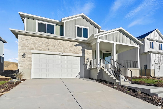 6941 W Farnsworth Peak Dr S Unit 316, West Jordan, UT 84081 - view of front facade featuring board and batten siding, stone siding, a porch, a garage, and concrete driveway