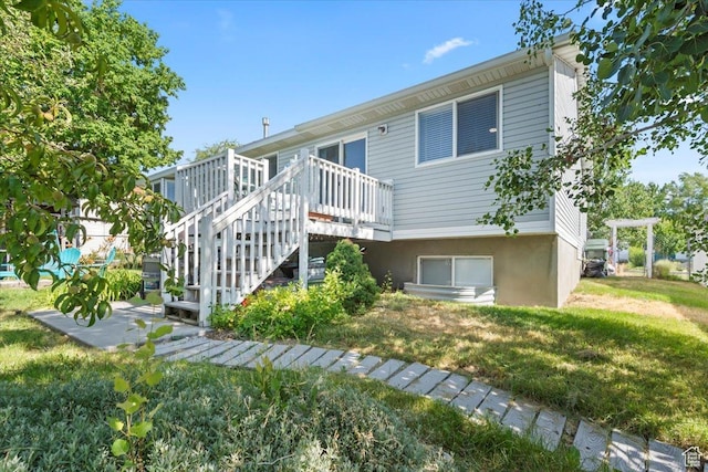 597 E 700 N, Tooele, UT 84074 - rear view of house featuring a wooden deck, a yard, and stairway