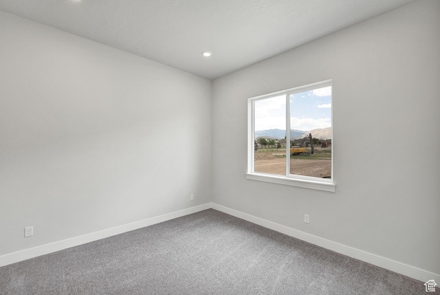 6199 W Wapiti Ridge Ln Unit 333, Herriman, UT 84096 - empty room with dark carpet, recessed lighting, and a mountain view