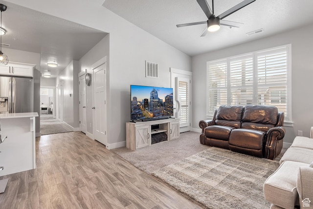 14642 S Mckellen Dr Unit C303, Herriman, UT 84096 - living area featuring a ceiling fan, light wood-style floors, and vaulted ceiling