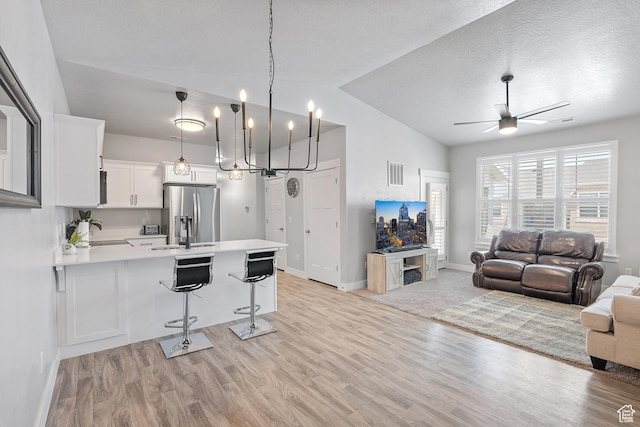 14642 S Mckellen Dr Unit C303, Herriman, UT 84096 - kitchen with stainless steel refrigerator with ice dispenser, lofted ceiling, a peninsula, light countertops, and open floor plan
