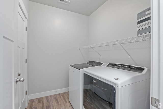 14642 S Mckellen Dr Unit C303, Herriman, UT 84096 - washroom with washer and dryer and wood finished floors