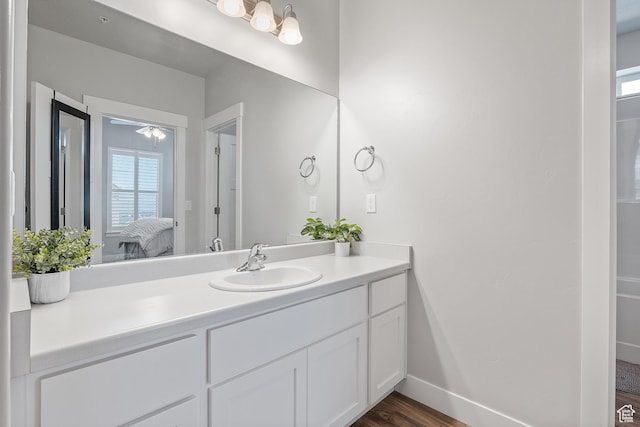 14642 S Mckellen Dr Unit C303, Herriman, UT 84096 - ensuite bathroom featuring vanity, wood finished floors, and healthy amount of natural light