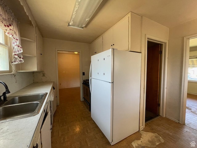 115 W Lester Ave, Murray, UT 84107 - kitchen featuring freestanding refrigerator, white cabinets, stove, light countertops, and wood finished floors