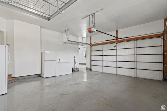 1076 W River Hill Dr, Spanish Fork, UT 84660 - garage featuring freestanding refrigerator and a garage door opener