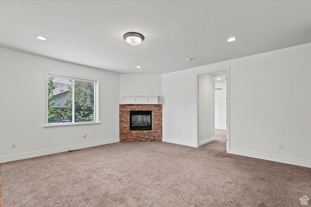 1076 W River Hill Dr, Spanish Fork, UT 84660 - unfurnished living room with carpet flooring, a stone fireplace, and recessed lighting