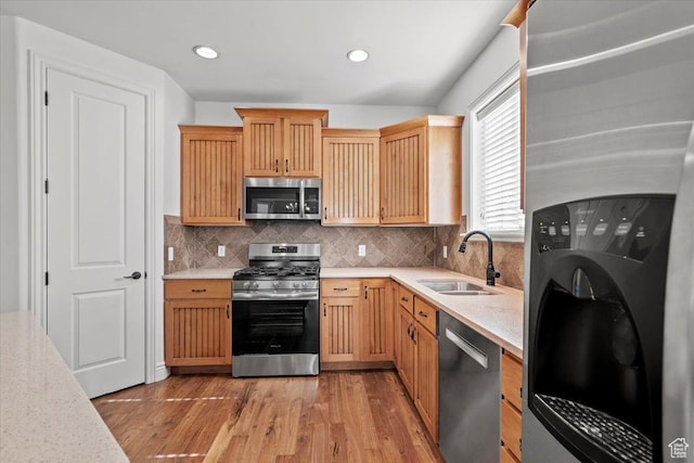 1076 W River Hill Dr, Spanish Fork, UT 84660 - kitchen with stainless steel appliances, light countertops, light wood-style floors, backsplash, and recessed lighting