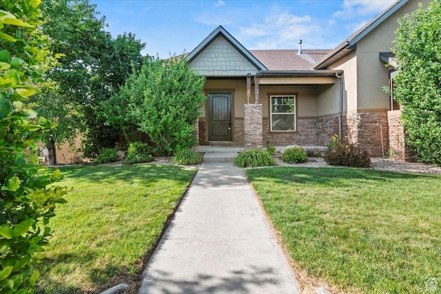 1076 W River Hill Dr, Spanish Fork, UT 84660 - view of front of property with stucco siding, a front lawn, and stone siding