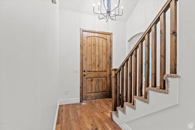 1076 W River Hill Dr, Spanish Fork, UT 84660 - entrance foyer featuring wood finished floors, stairway, a chandelier, and high vaulted ceiling