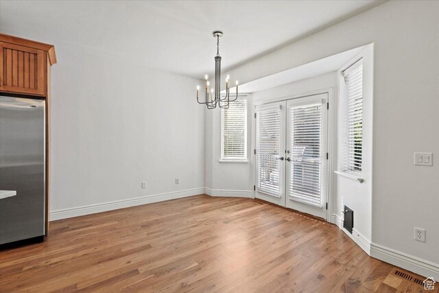 1076 W River Hill Dr, Spanish Fork, UT 84660 - unfurnished dining area with a chandelier and light wood-style floors