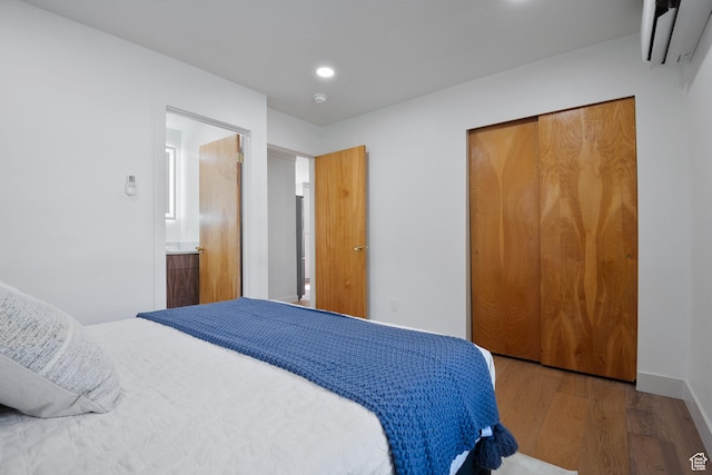 1214 E Parkway Ave, Salt Lake City, UT 84106 - bedroom with a wall mounted AC, wood finished floors, a closet, and recessed lighting