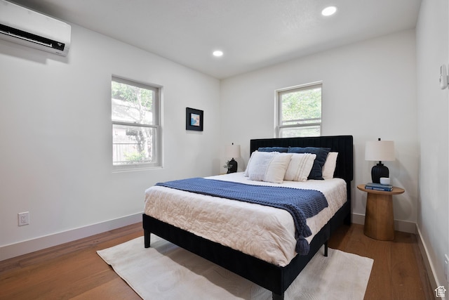 1214 E Parkway Ave, Salt Lake City, UT 84106 - bedroom with a wall unit AC, wood finished floors, and recessed lighting