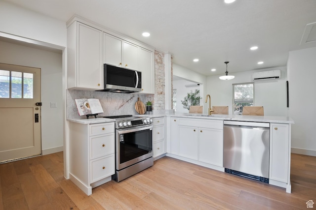1214 E Parkway Ave, Salt Lake City, UT 84106 - kitchen with stainless steel appliances, an AC wall unit, plenty of natural light, decorative backsplash, and recessed lighting