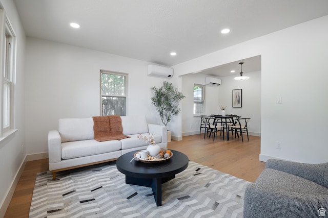 1214 E Parkway Ave, Salt Lake City, UT 84106 - living room featuring a wall mounted air conditioner, recessed lighting, and light wood-style floors