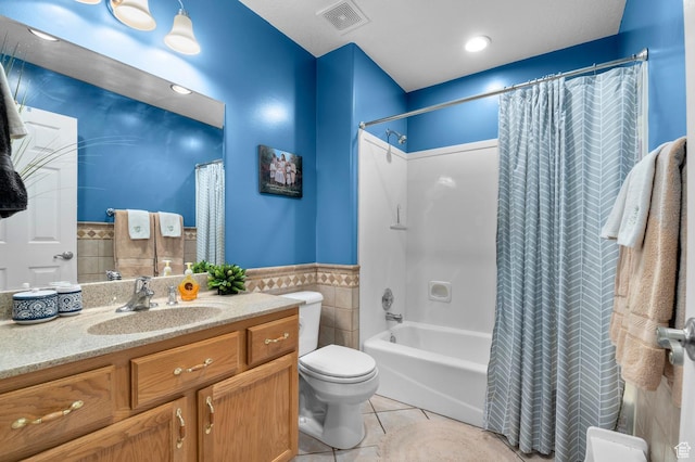 302 W 730 S, Tooele, UT 84074 - bathroom featuring tile walls, vanity, tile patterned floors, shower / bath combo with shower curtain, and a wainscoted wall