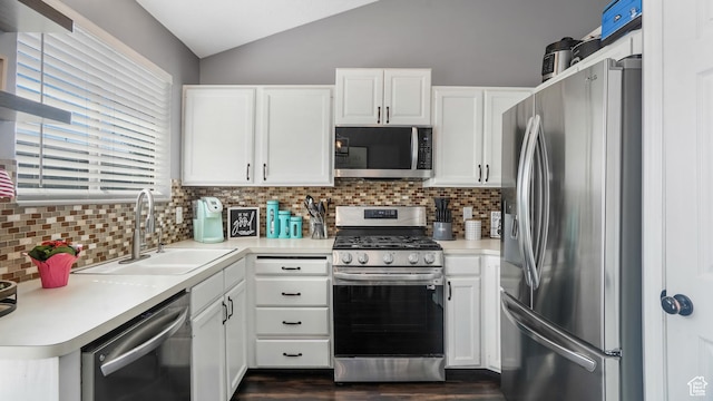 4878 S 3450 W, Roy, UT 84067 - kitchen featuring stainless steel appliances, lofted ceiling, tasteful backsplash, white cabinets, and light countertops