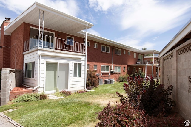 2260 E Murray Holladay Rd S Unit 22, Holladay, UT 84117 - rear view of property with a balcony, a lawn, and a chimney