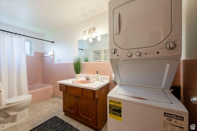 2260 E Murray Holladay Rd S Unit 22, Holladay, UT 84117 - bathroom with stacked washer / drying machine, tile walls, vanity, shower / tub combo with curtain, and a wainscoted wall