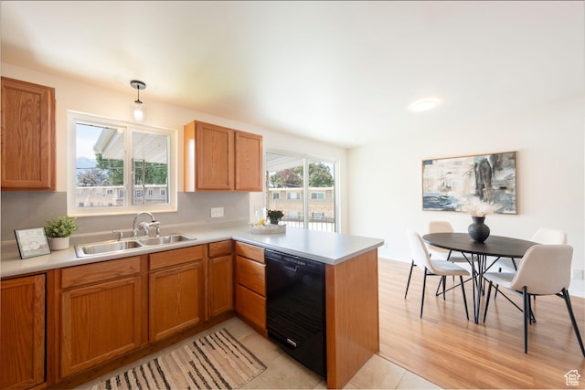 2260 E Murray Holladay Rd S Unit 22, Holladay, UT 84117 - kitchen featuring black dishwasher, a peninsula, light countertops, and brown cabinetry