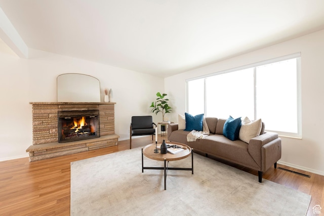 2260 E Murray Holladay Rd S Unit 22, Holladay, UT 84117 - living room featuring light wood finished floors and a stone fireplace