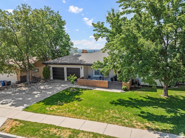 2451 E Cavalier Dr, Cottonwood Heights, UT 84121 - view of front of house with an attached garage, a front yard, and driveway
