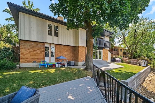 2451 E Cavalier Dr, Cottonwood Heights, UT 84121 - back of property featuring brick siding, a balcony, a yard, and a chimney