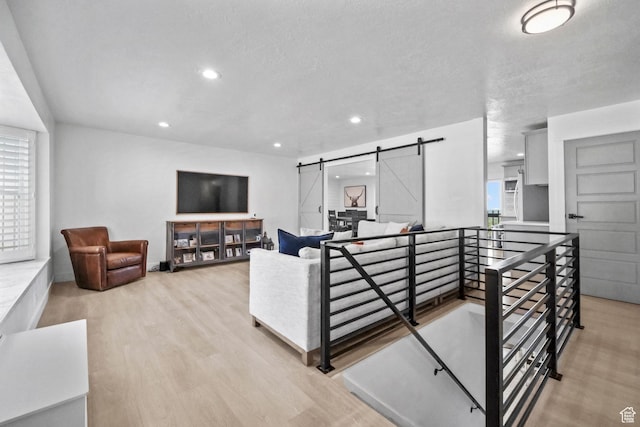 2451 E Cavalier Dr, Cottonwood Heights, UT 84121 - living area featuring a barn door, recessed lighting, healthy amount of natural light, and light wood-type flooring