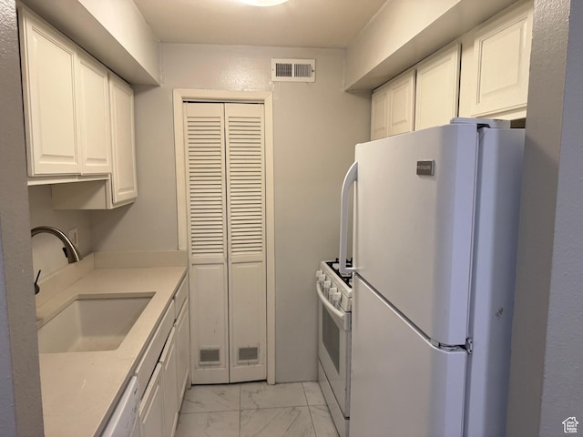 88 W 50 S Unit A4, Centerville, UT 84014 - kitchen with white appliances, light marble finish flooring, white cabinetry, and light countertops