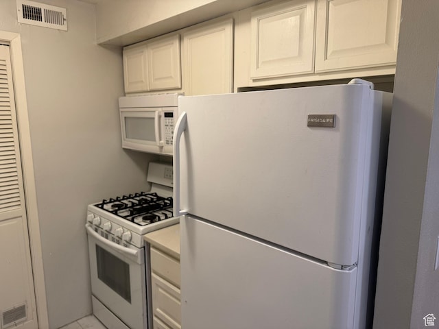 88 W 50 S Unit A4, Centerville, UT 84014 - kitchen featuring white appliances, light countertops, and white cabinetry