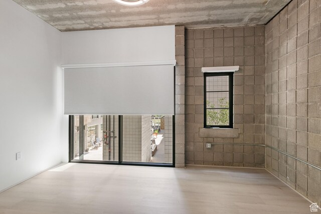 360 W 300 S Unit 233, Salt Lake City, UT 84101 - spare room featuring wood finished floors and plenty of natural light