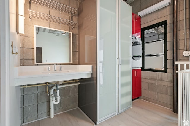 360 W 300 S Unit 233, Salt Lake City, UT 84101 - bathroom with wood finished floors, a ceiling fan, and stacked washing machine and dryer