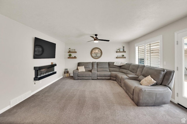 8322 S Copper Vista Cir, West Jordan, UT 84081 - living area featuring ceiling fan, a glass covered fireplace, and carpet