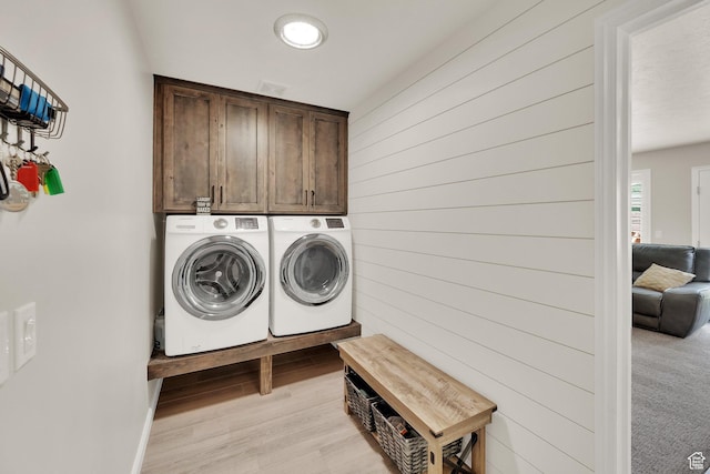 8322 S Copper Vista Cir, West Jordan, UT 84081 - laundry room featuring cabinet space, washing machine and dryer, light wood-type flooring, and wood walls