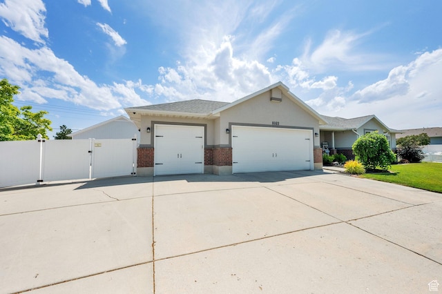 8322 S Copper Vista Cir, West Jordan, UT 84081 - single story home with brick siding, a gate, an attached garage, concrete driveway, and stucco siding