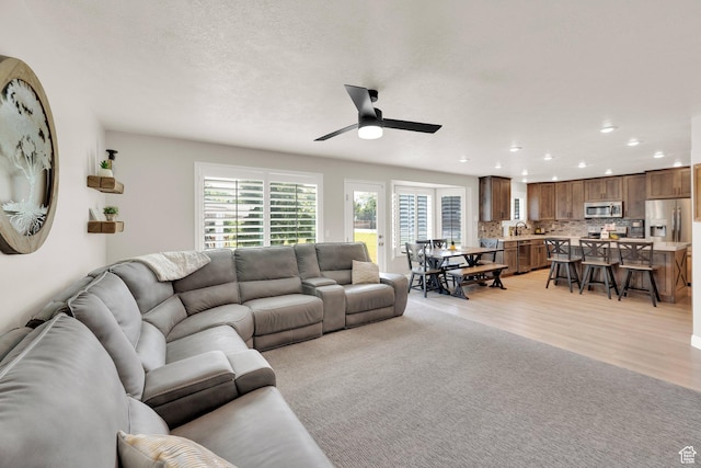 8322 S Copper Vista Cir, West Jordan, UT 84081 - living area with ceiling fan, recessed lighting, and light wood-type flooring